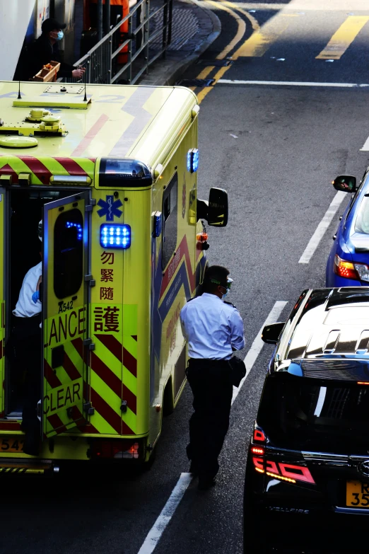 a man wearing an ambulance uniform boarding a ambulance