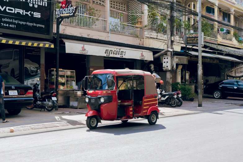 a small red motorcycle parked on the side of the street