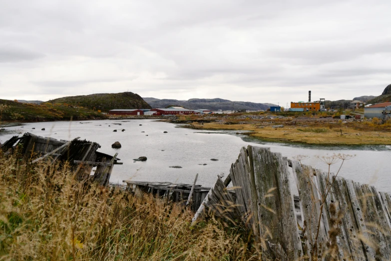 there are some broken water vessels sitting by the shore