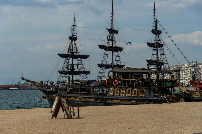 a black pirate ship sitting on a beach