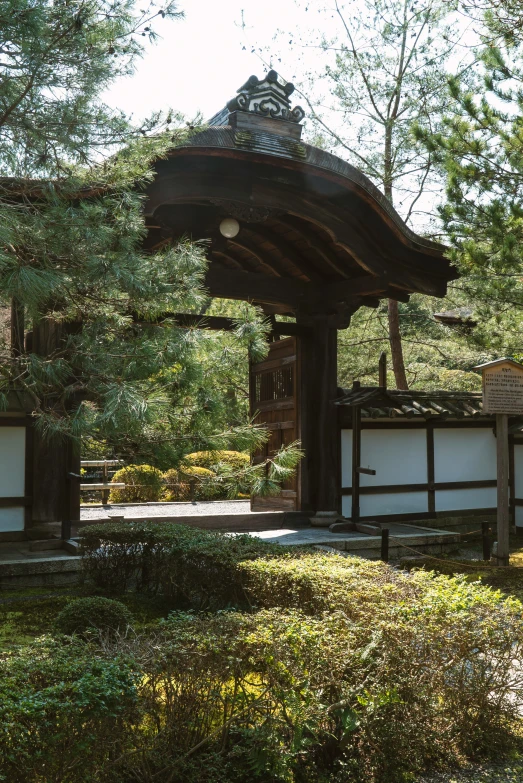 an old wooden gazebo in the middle of a park