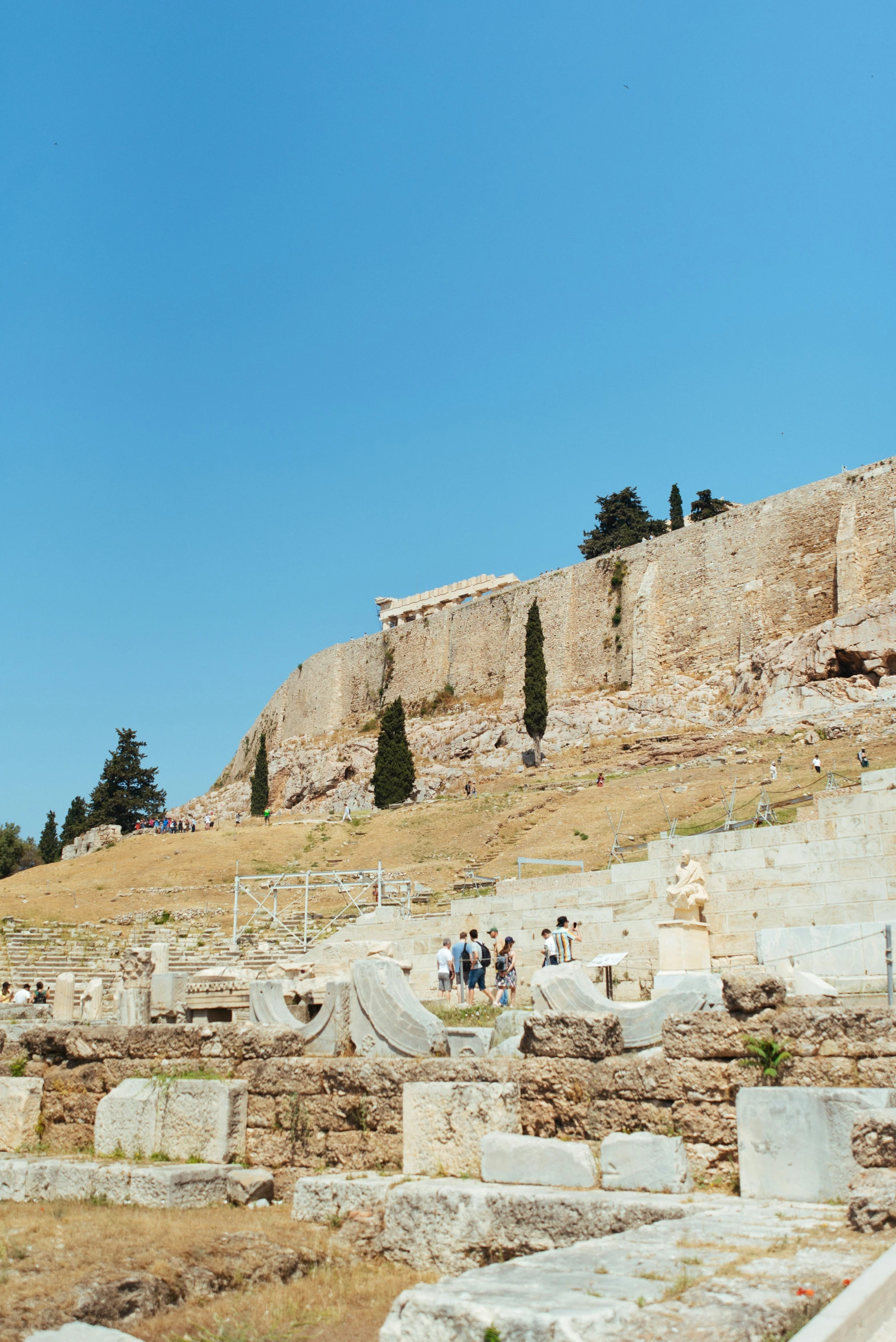 some ancient ruins with some people walking by