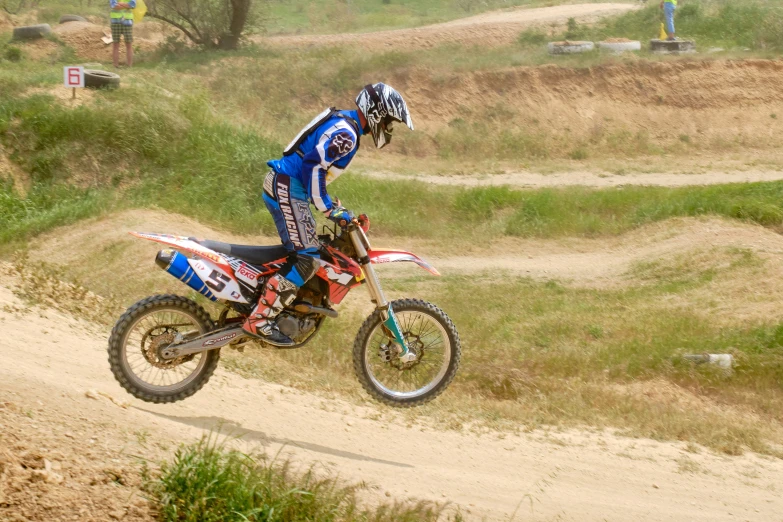 the man is riding a dirt bike on a track