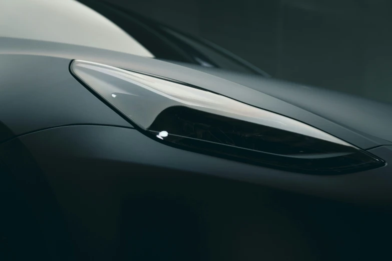 the hood or fender of a sleek, new black sports car