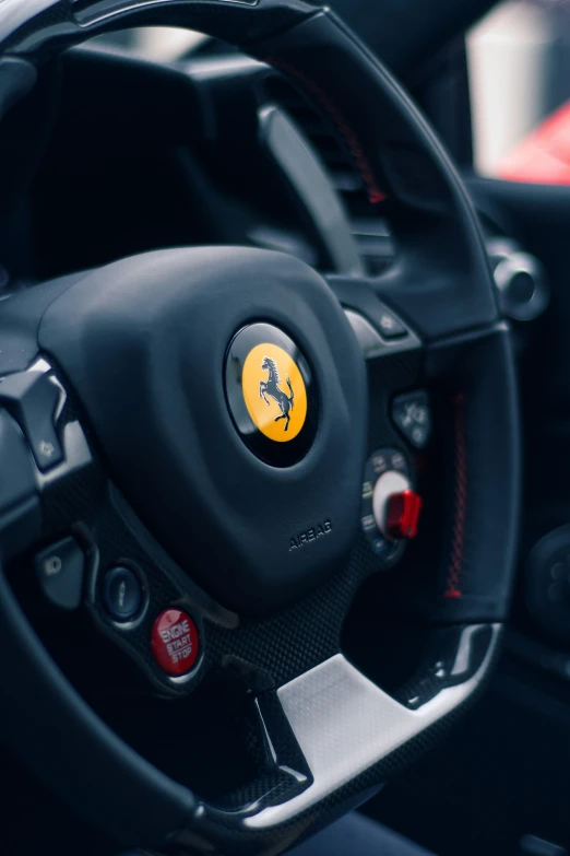 steering wheel with ferrari badge on black leather