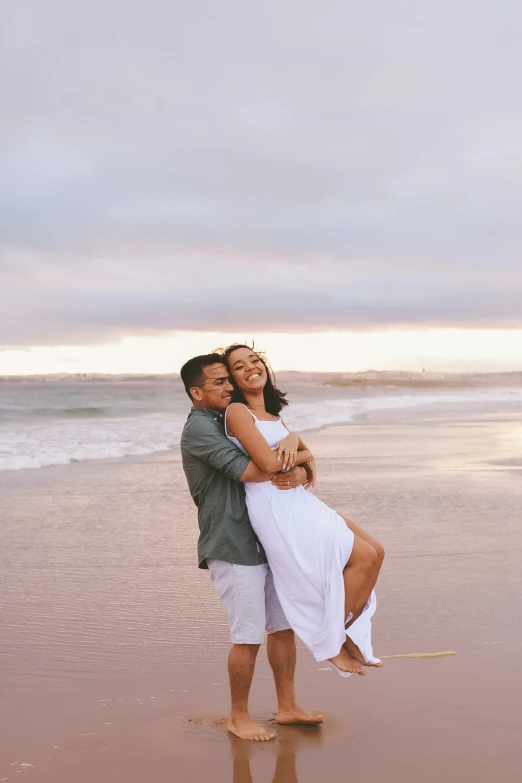 an image of a couple emcing on the beach