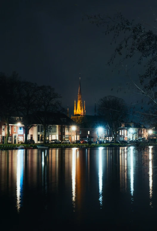 a large building sitting over a small lake at night