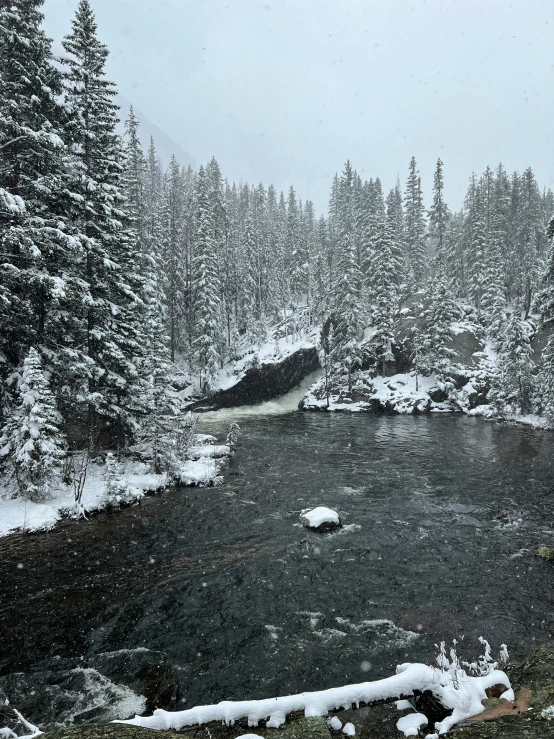 a small river with snow on the ground