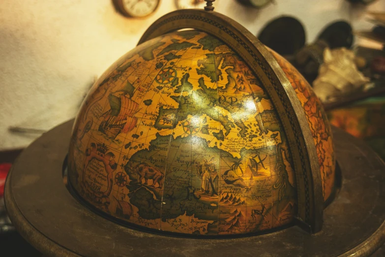 a brown wooden domed dish with a colorful painting on it