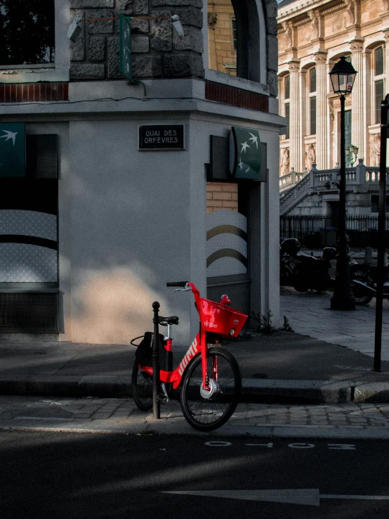 a red bicycle is parked on the side of a street