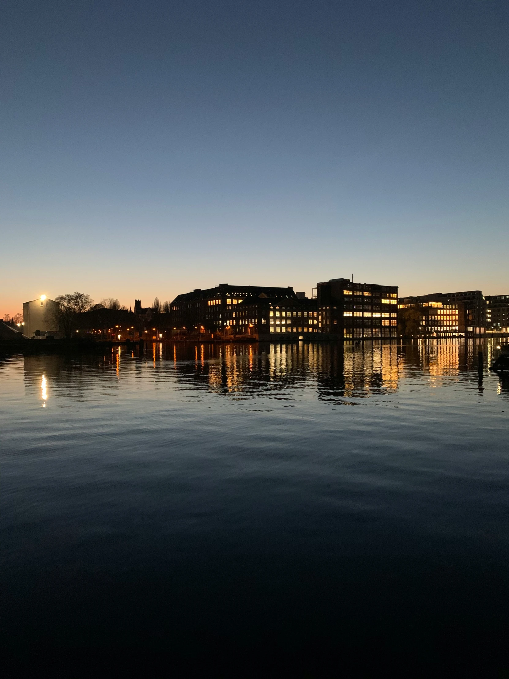 a body of water with many buildings in the background