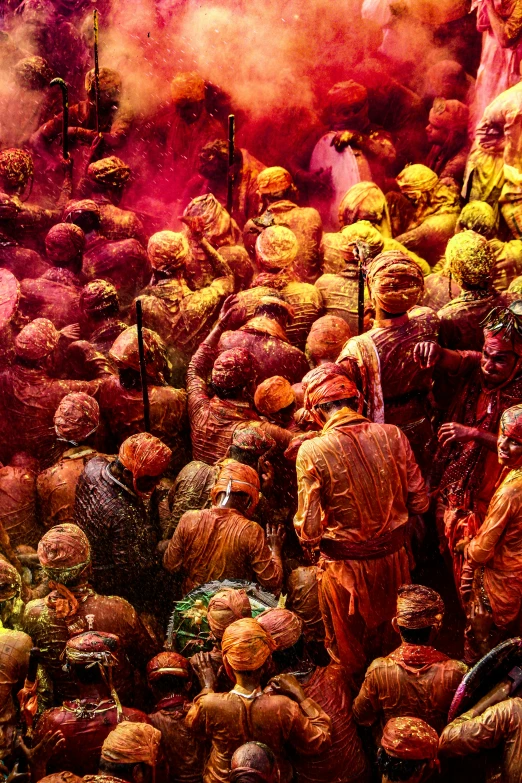 a group of people surrounded by colorful powders