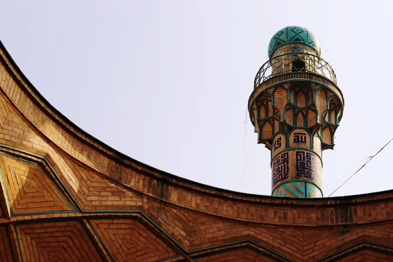 the roof of a brick building with a spire on top