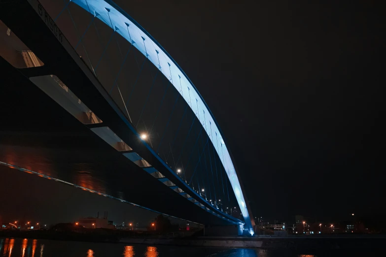 a long dark night sky with lights reflected in the water