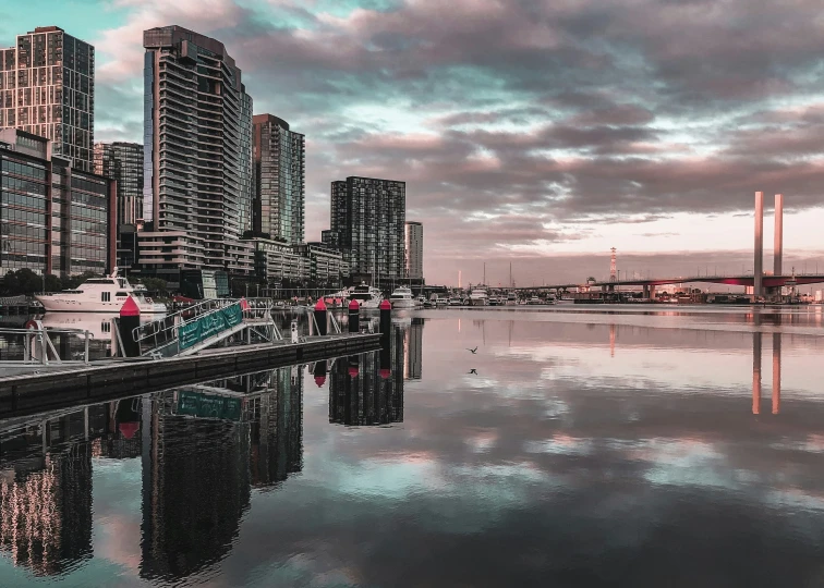 the city skyline is reflecting the water