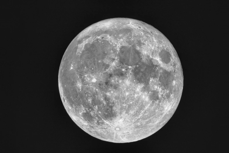 full moon in black sky with clouds below