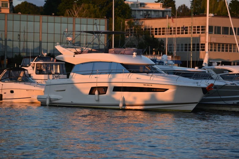 boats docked at a marina in front of large buildings