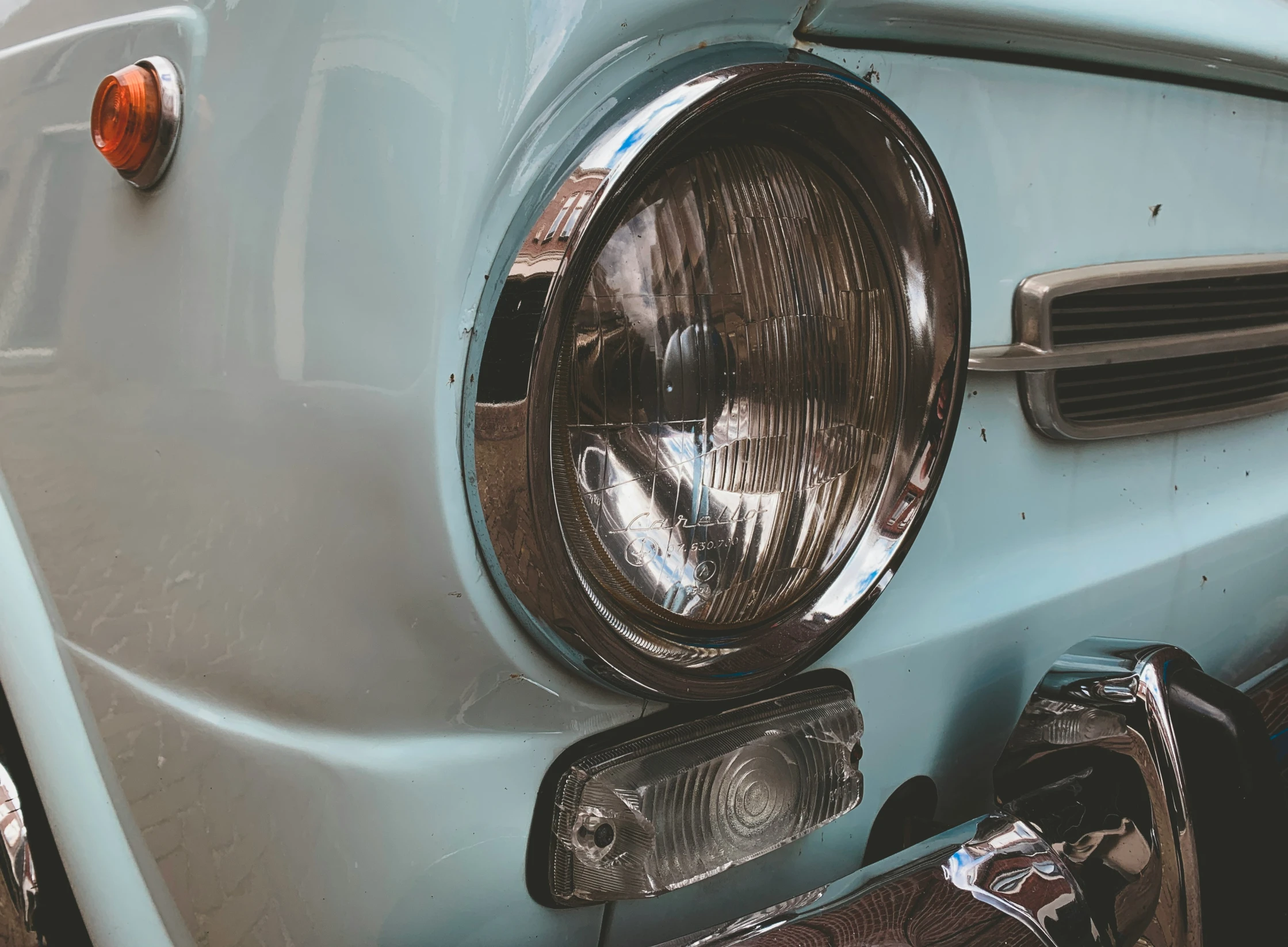 the front of an old blue sports car