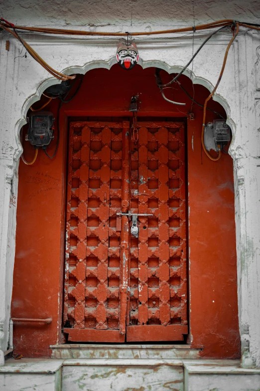 a door with red iron doors on it that leads to an outside porch