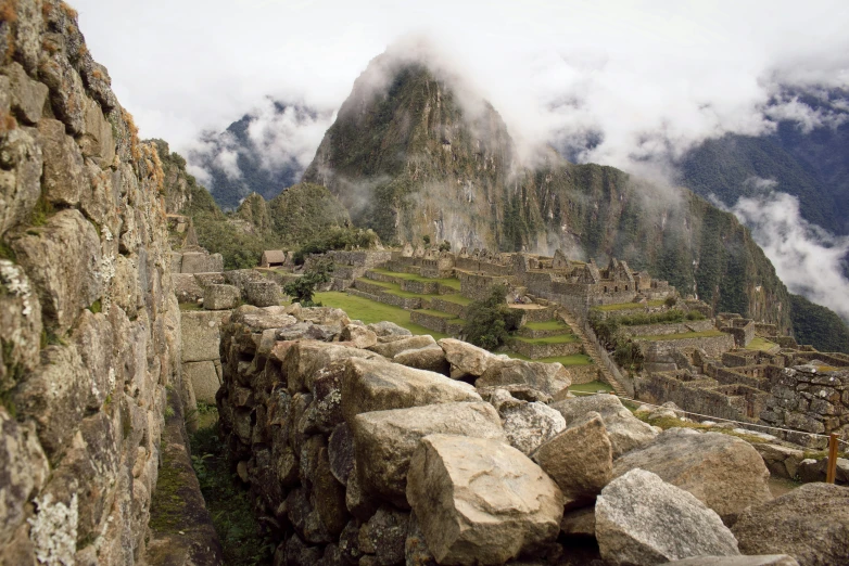 stone ruins and mountain with a cloudy sky