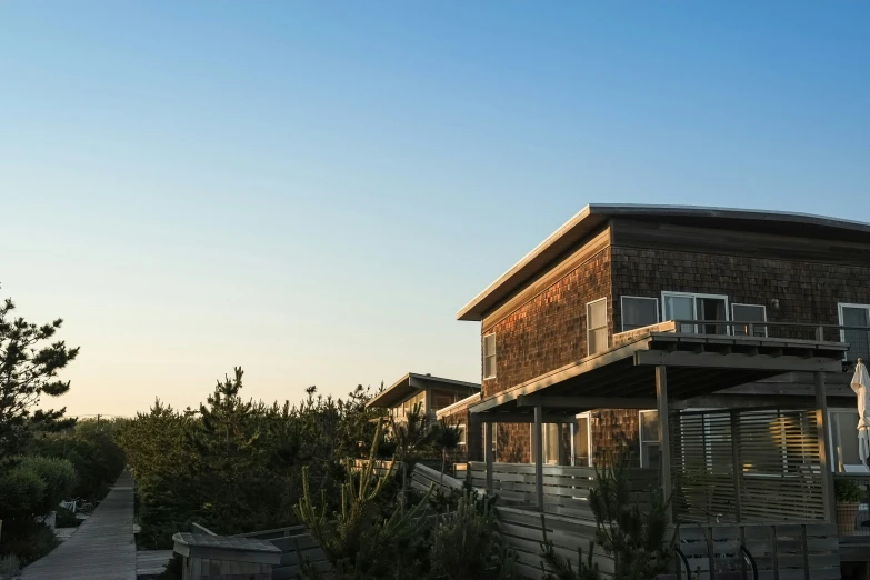 the wooden house is standing alone outside of the house