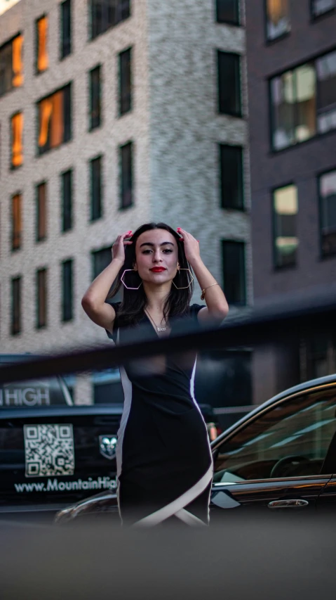 a woman standing outside of a building on a cell phone