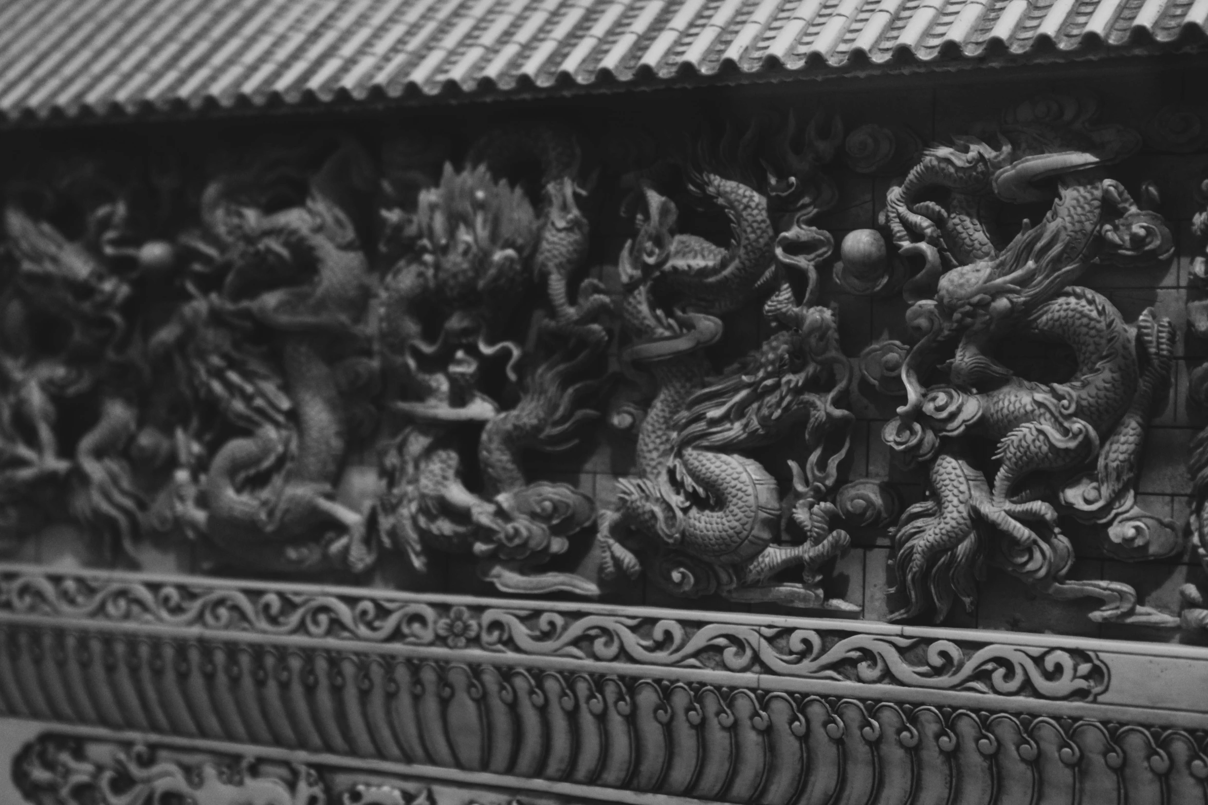 carvings on the wall of a building in an asian style