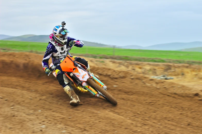 a person riding a motorcycle on a dirt track