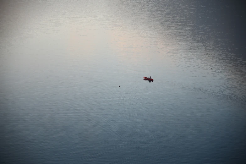 this is a view of a small boat floating on the water