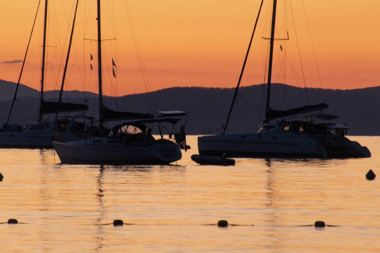 boats are in the water while one boat is out at sea