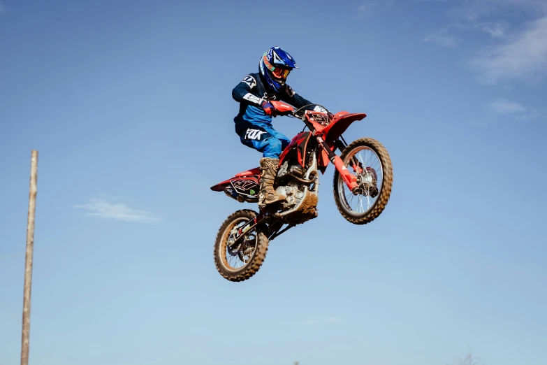 a man flying through the air riding a dirt bike