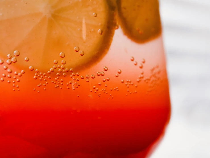 a drink with water and an orange slice