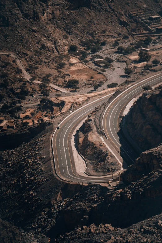 the view from an airplane looking down on a curvy highway