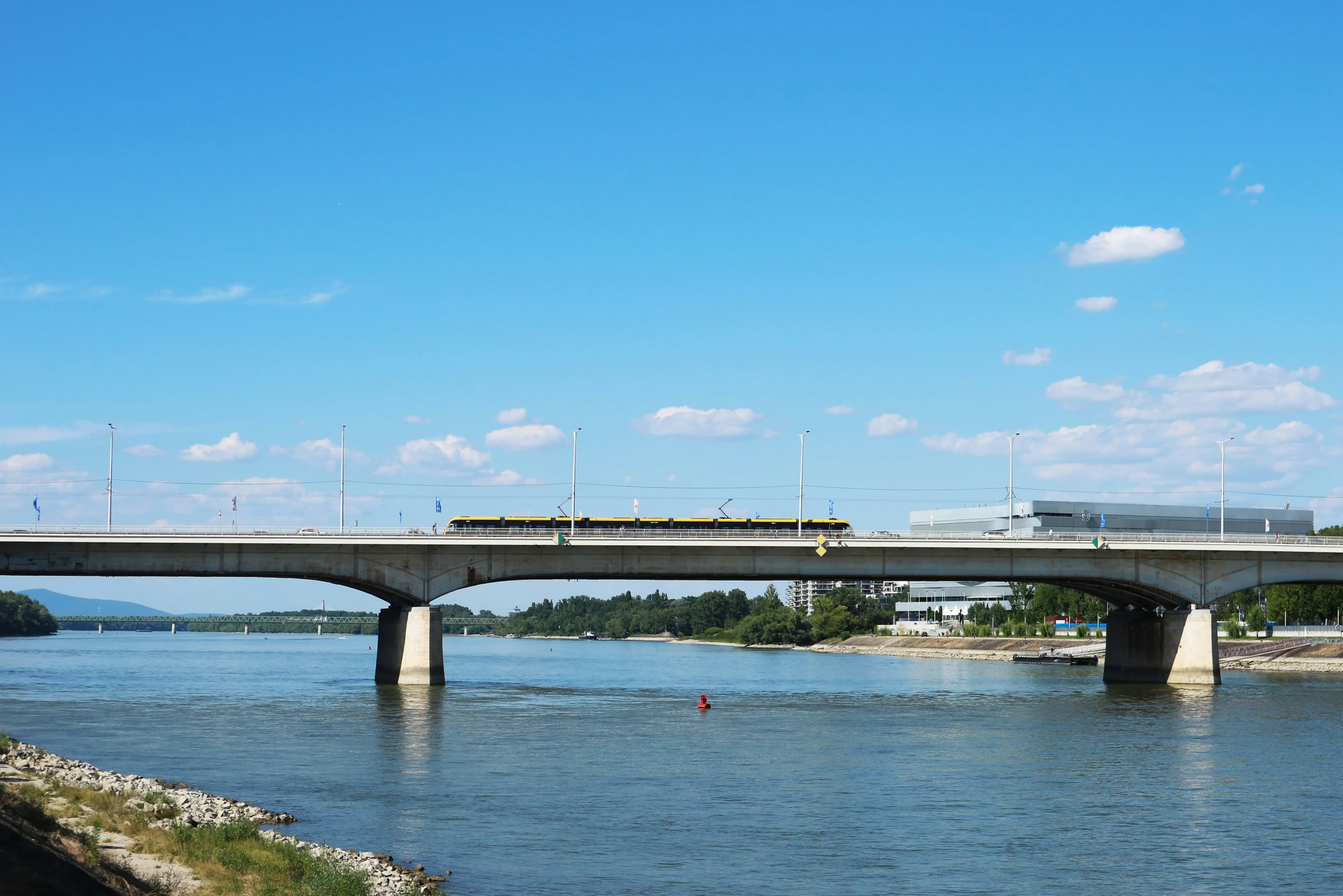 a train is crossing over a large bridge