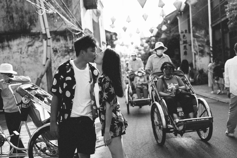 a young man and woman are looking at their baby carriages