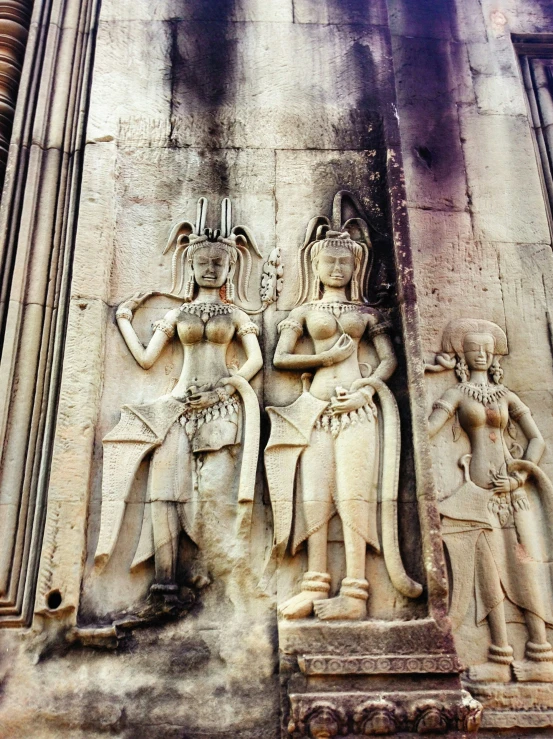 a close up of statues on a wall