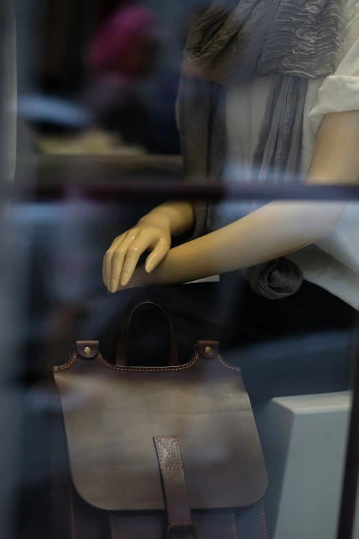 a dummy handbag sitting on a display case