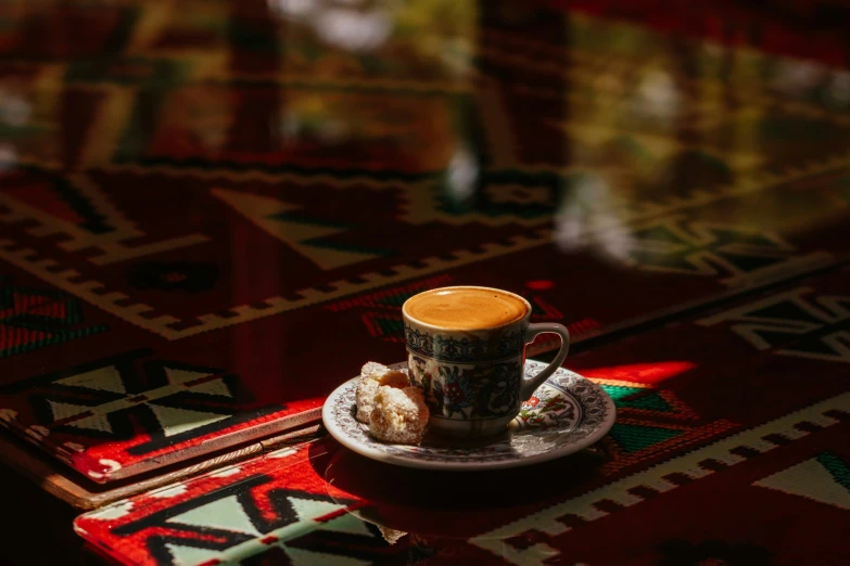 a cup of coffee sitting on top of a plate