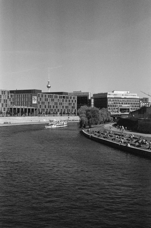 black and white image of the river next to buildings