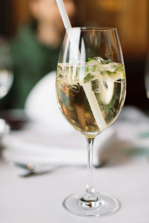 a wine glass filled with liquid on a table