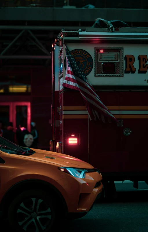 a firetruck is parked outside with a american flag