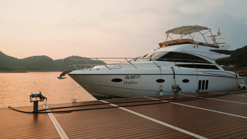 a boat is moored along the pier near mountains