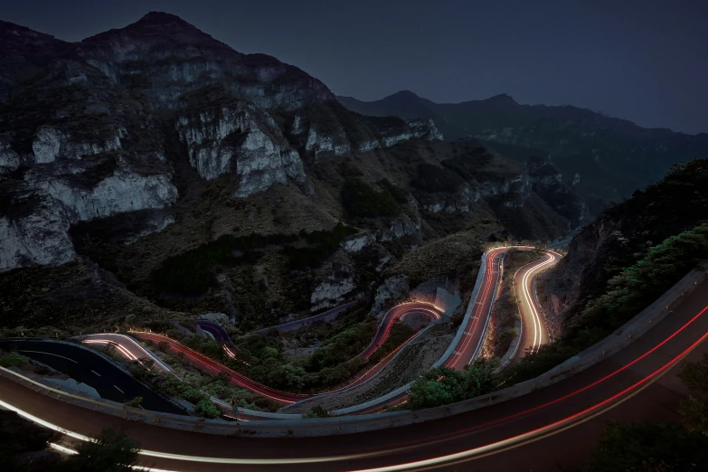 a night time view of an interstate in the mountains