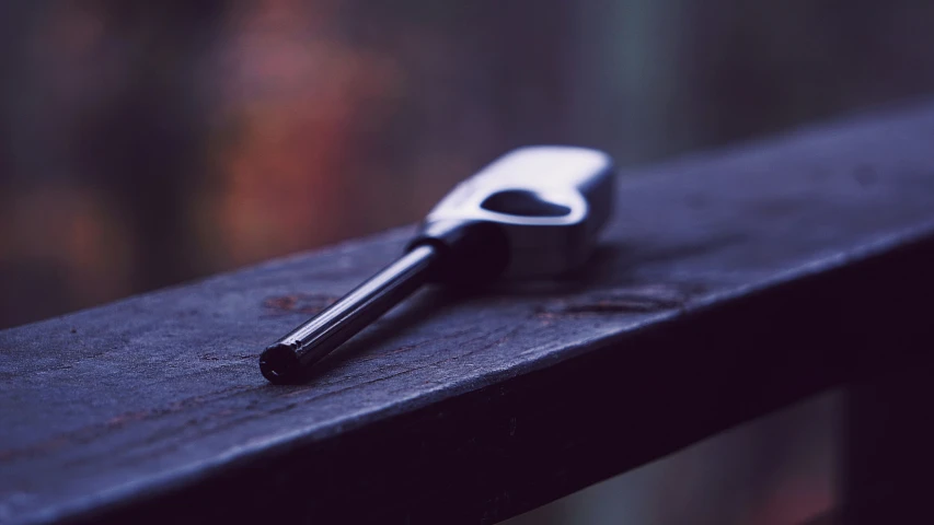 the silver key is on top of the black wood