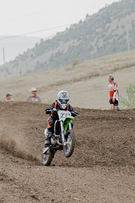 a person riding a dirt bike on a dirt road