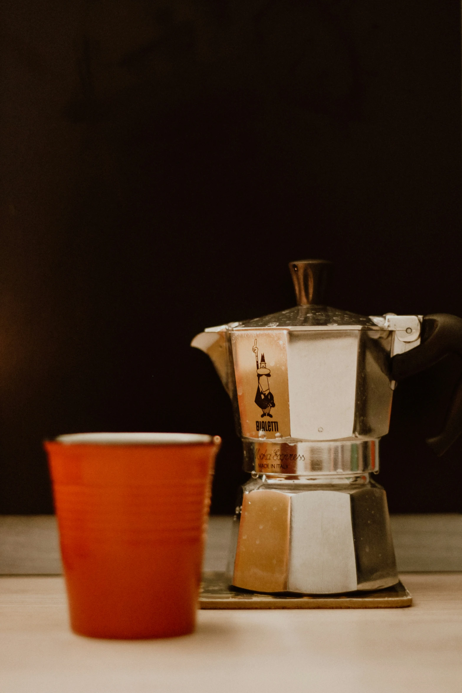 a metallic coffee maker sitting on top of a counter