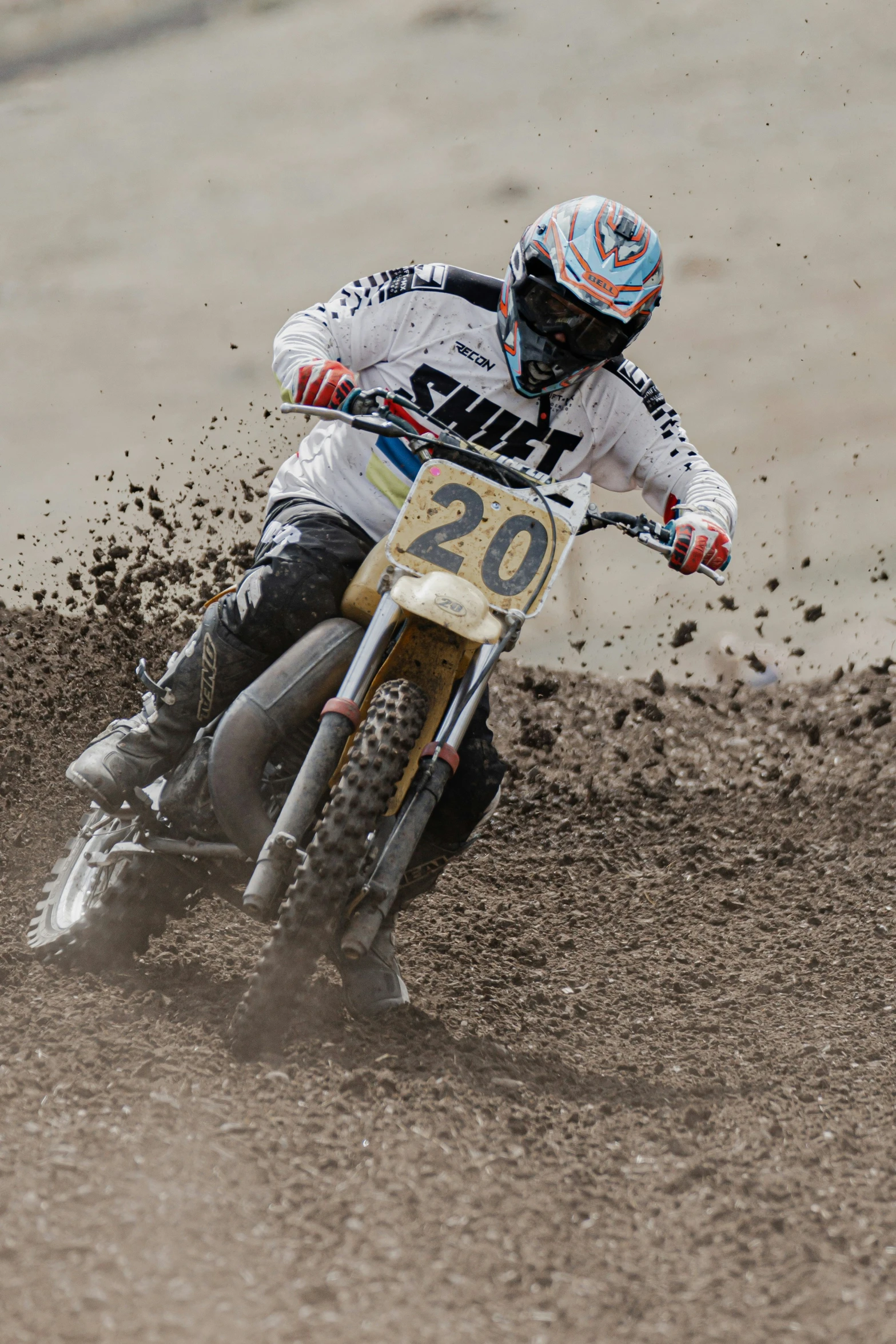 there is a motorcyclist racing around a dirt track