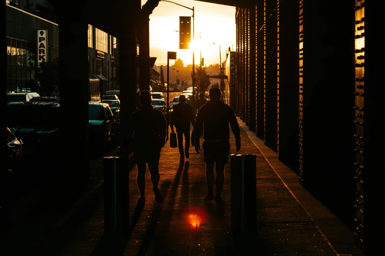 people walk down the street in silhouette