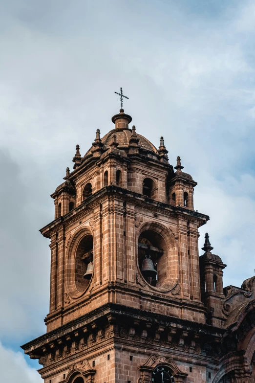 a clock is at the top of a very tall tower