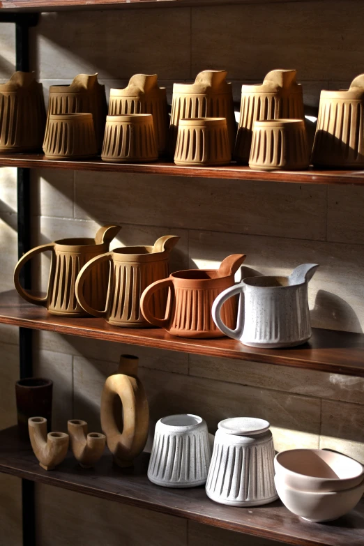 the shelves in this store display different pottery and pottery items